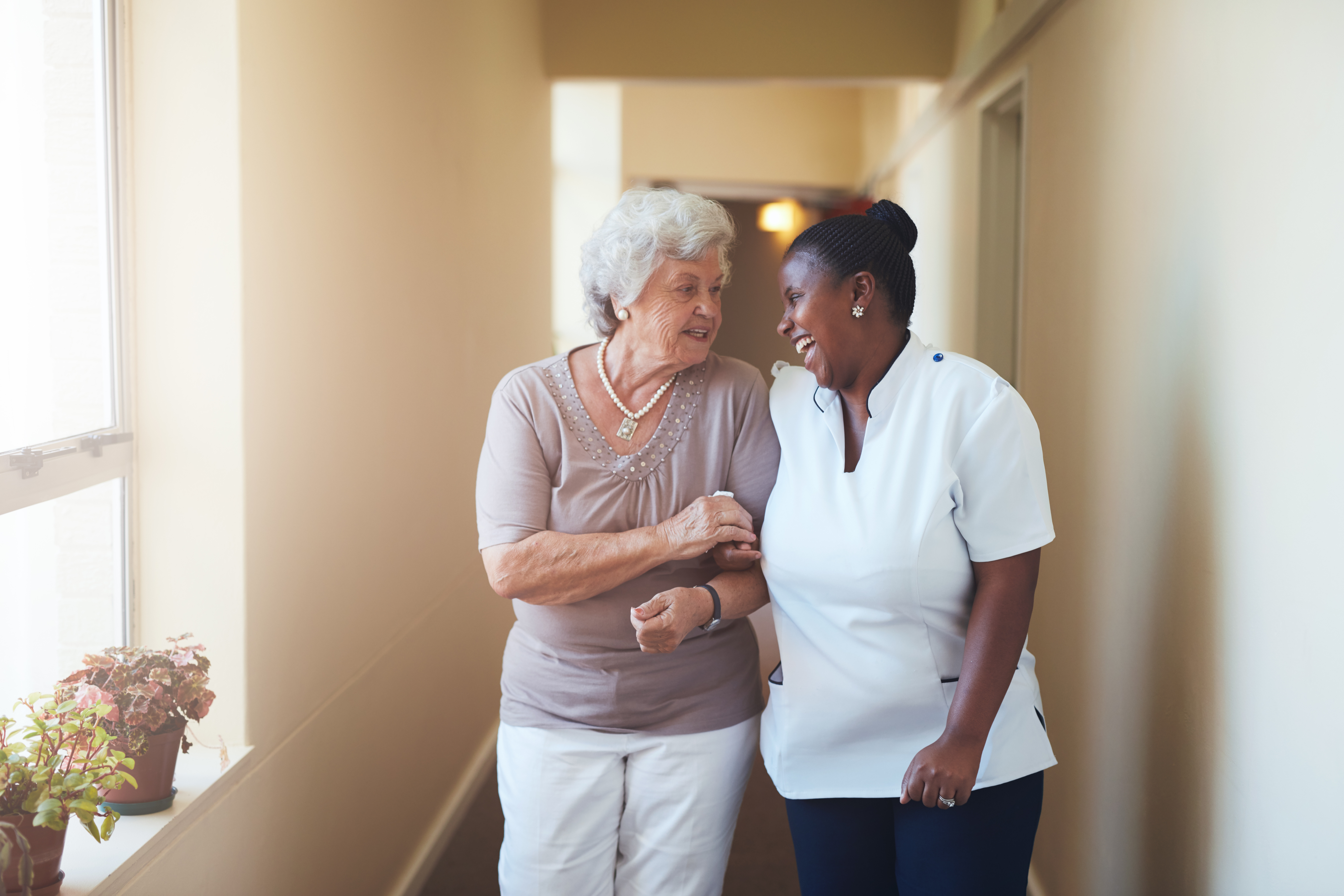 Portrait of Happy Female Caregiver and Senior Woman